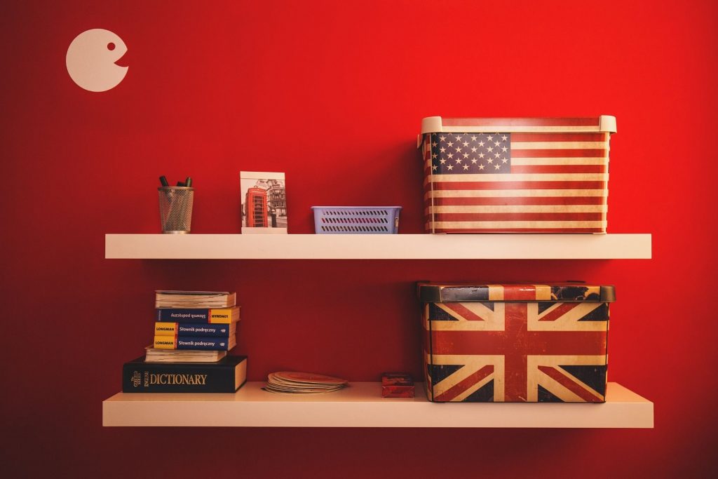 with USA and UK flags and dictionaries on the shelf