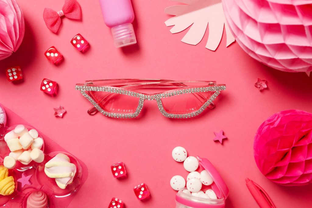Barbie accessories on a pink background. The best barbie quotes